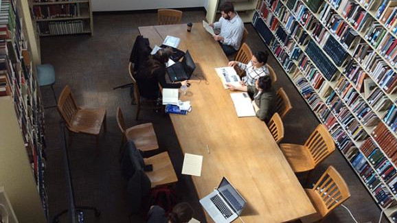 View from above of a group of students working at a large table.