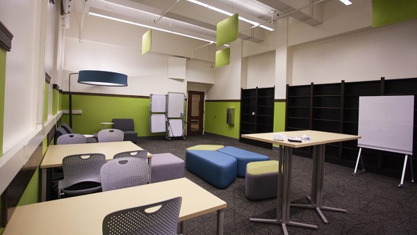 A view of the same room from a different angle which shows large bookshelves built into the wall.