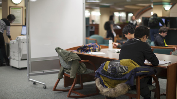 Students working in an open seating area.