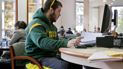 A student working at a library computer.