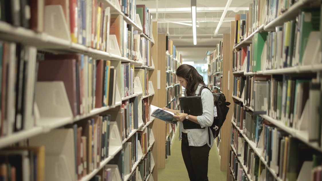 woman browsing library stacks