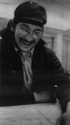 In a photo from the Daily Emerald student newspaper, Ron Eachus smiles broadly as he looks over the contents of his FBI file. 