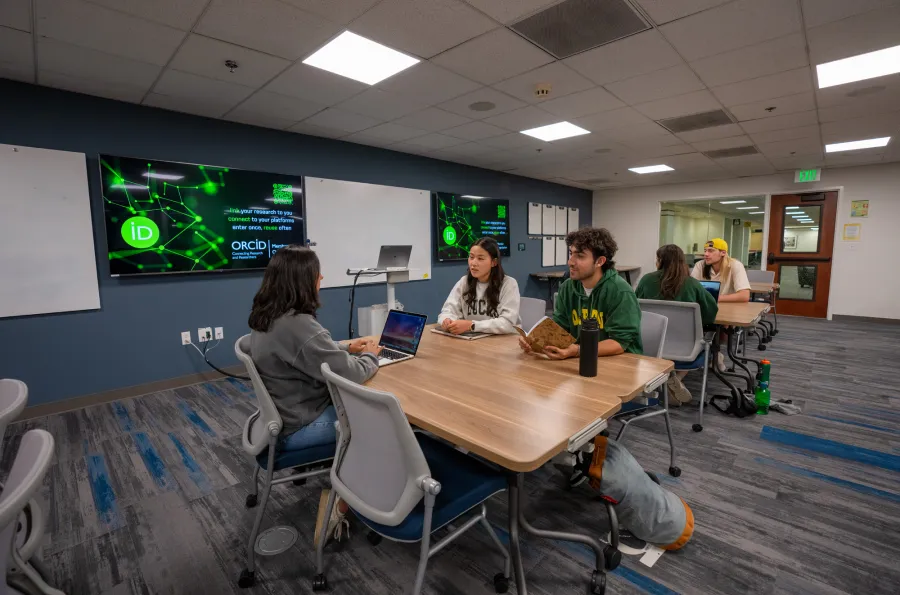 A group of students at desks in the DREAM Lab classroom